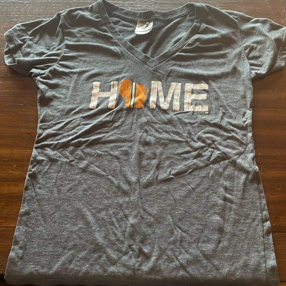 Grey shirt that says “Home” with Wisconsin logo